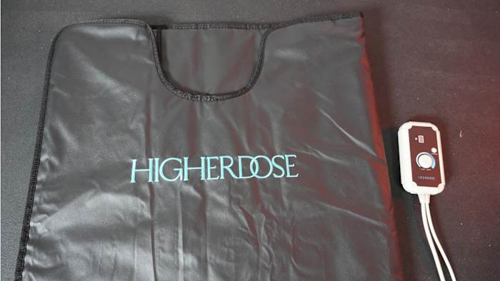 Closeup of top of black Higherdose Infrared Sauna Blanket with blue text and control knob